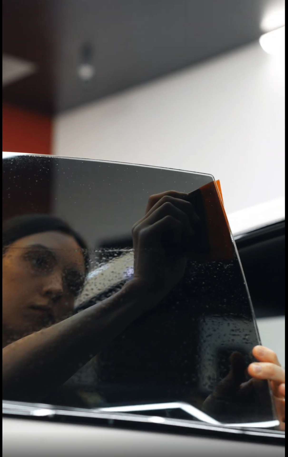 Close-up of ceramic tint application on car window